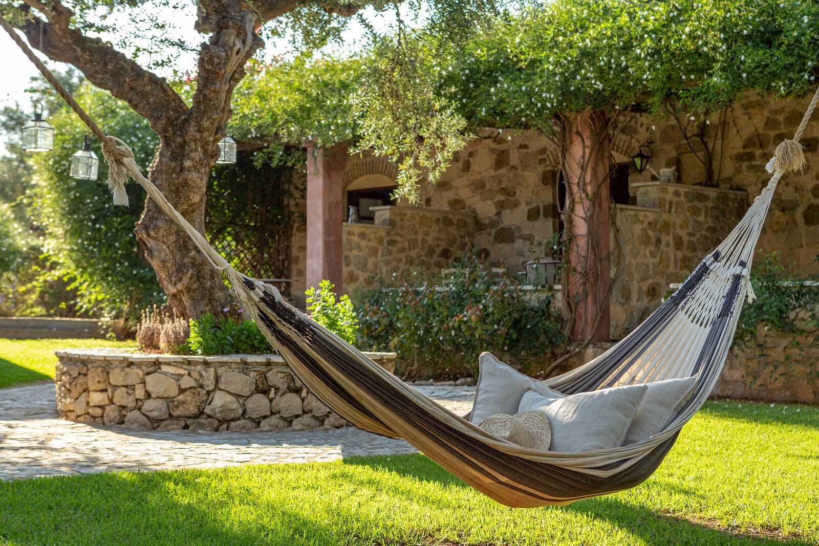 A hammock tied between the trees in the garden