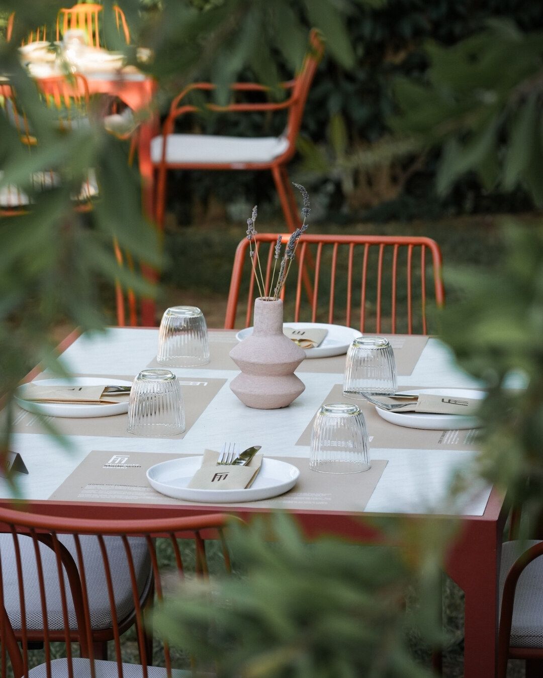 A table laid for dinner among the plants