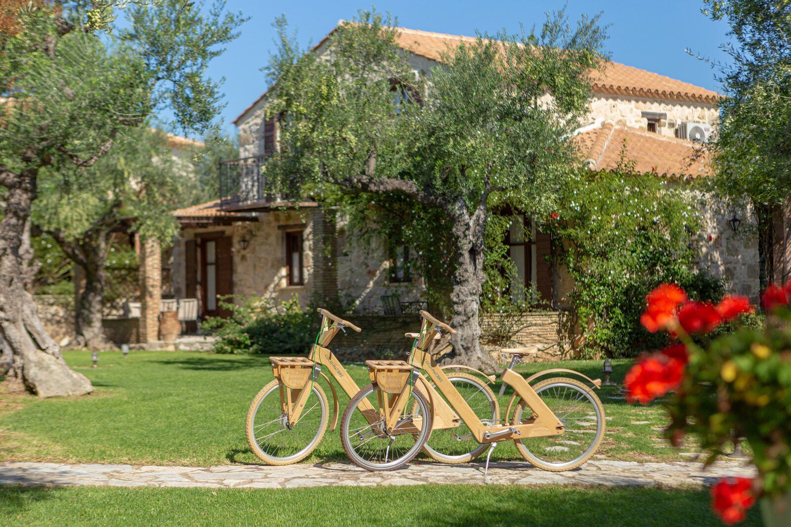 Bicycles on the lawn in front of the stone houses