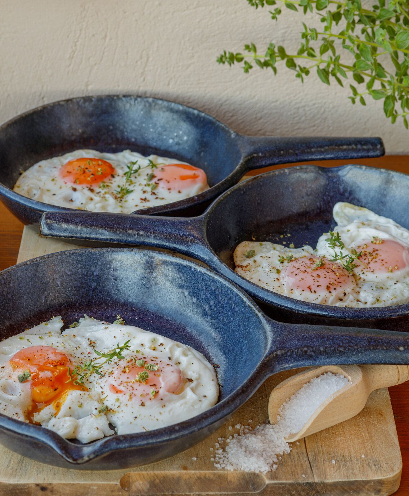 Fried eggs served in small iron pans