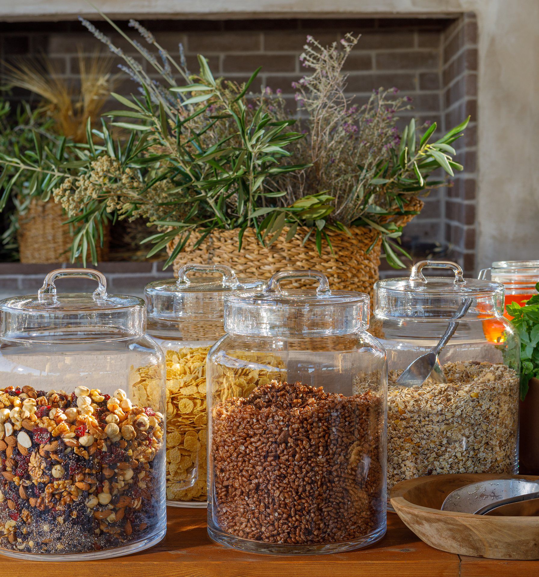 Glass jars of nuts, cereals and oats on the breakfast buffet