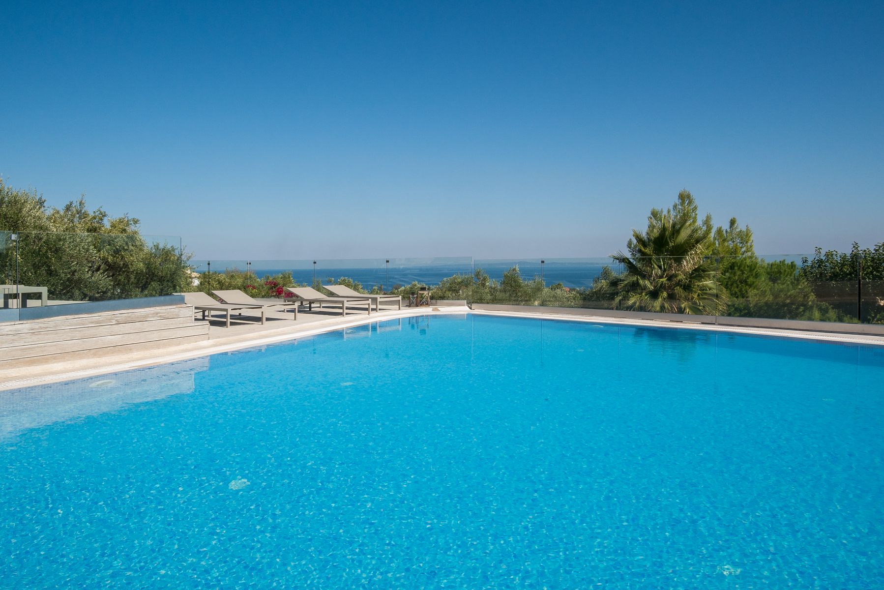 The pool terrace looking over olive groves to the open sea