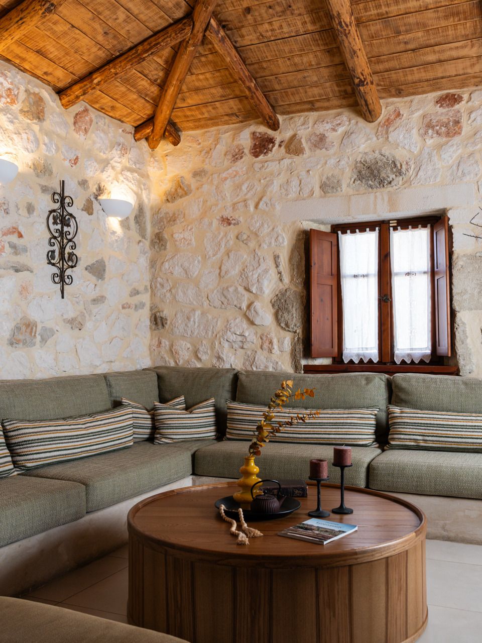 Superior Villa sitting room with a built-in sofa and stone walls